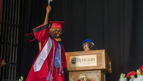 Student graduating and walking across stage to receive diploma