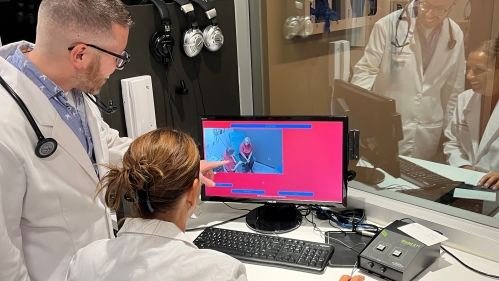Two students look at image on computer