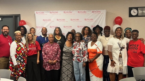 Members of the community pose with Rutgers Nursing staff and students