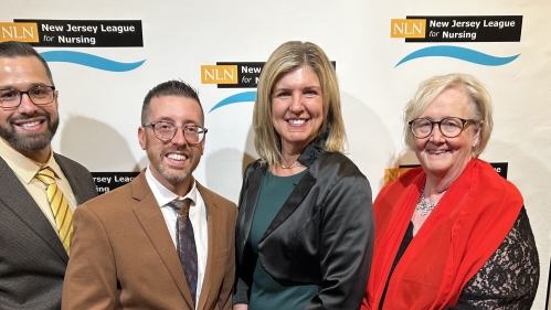 Faculty pose together at event