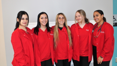 Student nurses pose together in Rutgers Official Gear