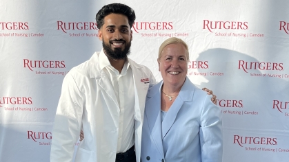 Student poses with faculty