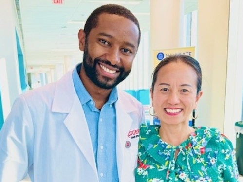 Student poses with faculty member