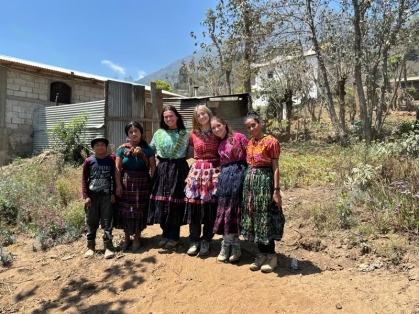 Nursing students outside pose with family