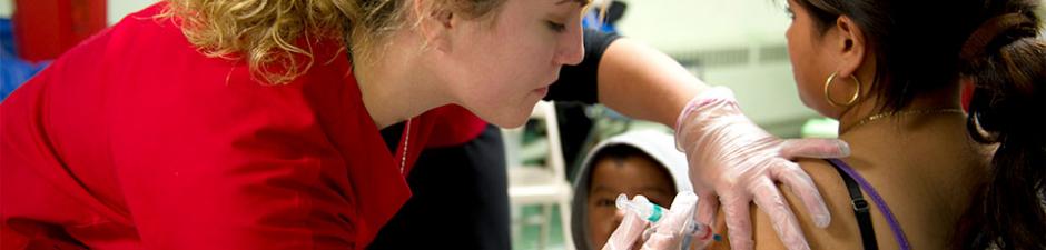 Rutgers School of Nursing-Camden student delivers flu shot at Camden clinic